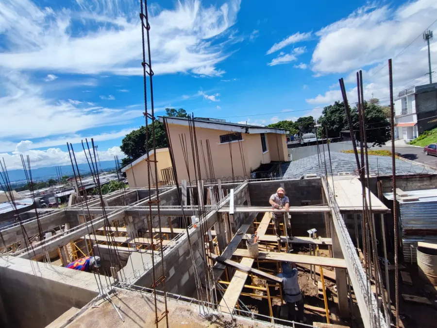 Casa habitacional en construcción con muros de block, columnas armadas y apuntalamiento de madera, San Cristóbal